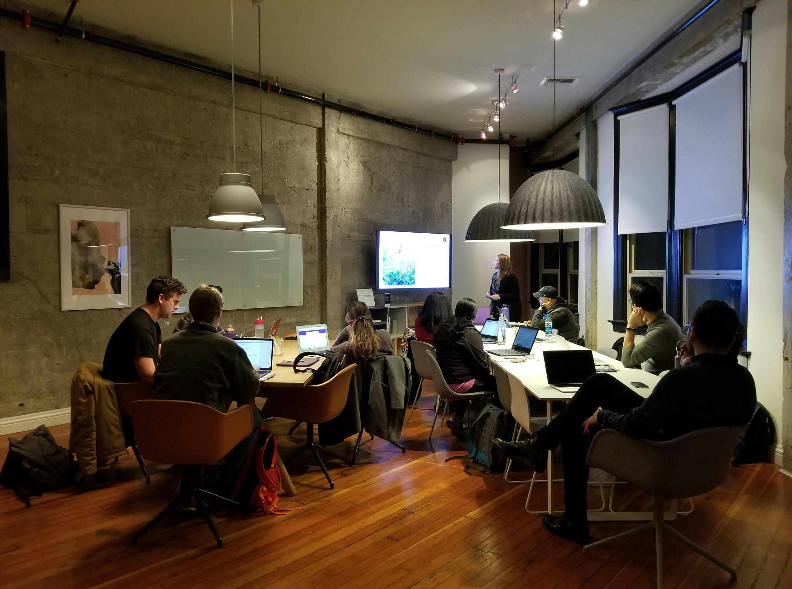 Group of professionals in a workshop setting with laptops, symbolizing Brasstown Consulting’s focus on training, digital literacy, and building confidence with new technology